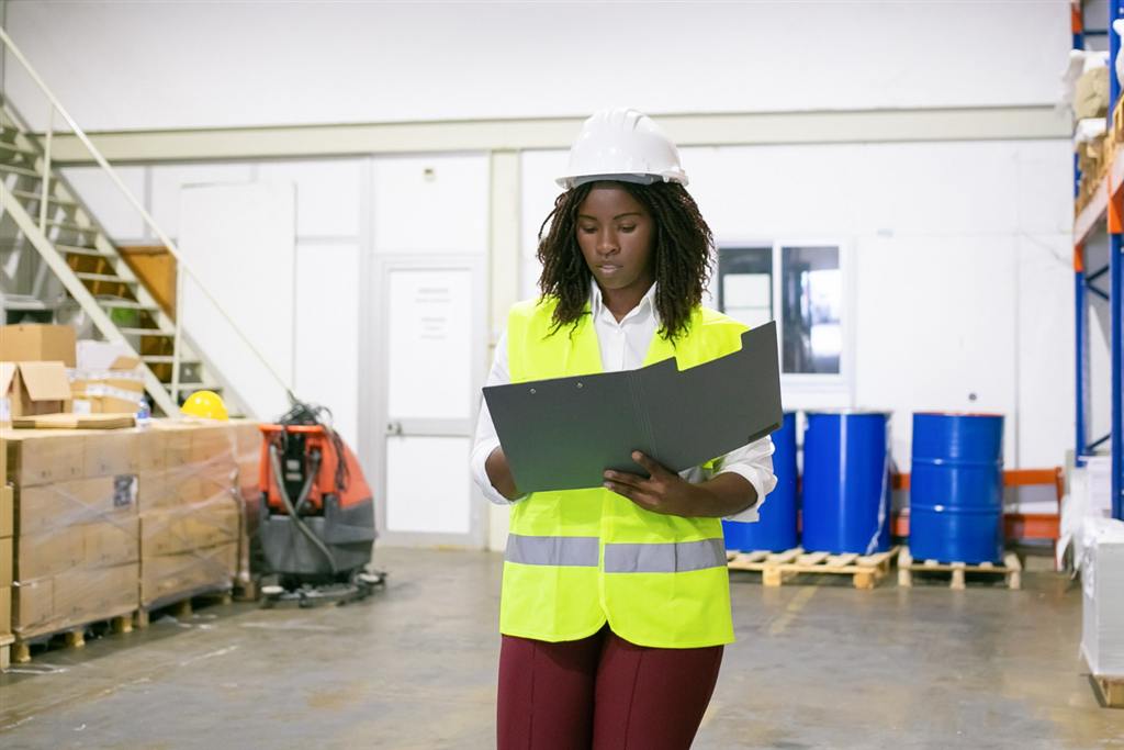 A supplier carrying out a check on the warehouse floor.